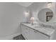 Bathroom featuring double sink vanity, marble countertop, round mirrors, and decorative lighting at 821 Onslow St, Durham, NC 27705
