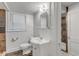 Bathroom featuring toilet, single sink vanity, mirror, and shower with stone tiling at 821 Onslow St, Durham, NC 27705