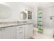 Bright bathroom with white vanity, marble countertop, and tiled shower-tub combination at 821 Onslow St, Durham, NC 27705