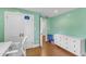 Inviting bedroom featuring hardwood floors, a white dresser, and calming mint green walls at 821 Onslow St, Durham, NC 27705