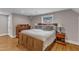 Large bedroom with hardwood floors, two bedside tables, and natural light at 821 Onslow St, Durham, NC 27705