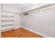 A walk-in closet features built-in shelves and a hanging rod offering ample storage space at 821 Onslow St, Durham, NC 27705