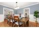 Bright dining room with hardwood floors, white trim, and stylish light fixture at 821 Onslow St, Durham, NC 27705