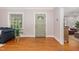 Inviting foyer with hardwood floors, a sage colored door, and lots of natural light at 821 Onslow St, Durham, NC 27705