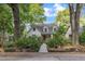 Inviting two-story home with a white facade and lush, mature trees at 821 Onslow St, Durham, NC 27705