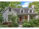 Quaint white brick house with a walkway through landscaped garden at 821 Onslow St, Durham, NC 27705