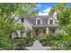 Charming white brick home with dormers and a beautifully landscaped front yard at 821 Onslow St, Durham, NC 27705