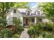 Beautiful home exterior with colorful flowers, a brick facade, and a welcoming front porch at 821 Onslow St, Durham, NC 27705