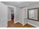 Hallway area featuring hardwood floors, neutral paint, and a view of the bathroom at 821 Onslow St, Durham, NC 27705