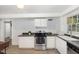 This modern kitchen features stainless steel appliances, white cabinetry and a window at 821 Onslow St, Durham, NC 27705