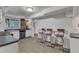 Basement kitchen area with stainless steel appliances, barstool seating, and ample counter space at 821 Onslow St, Durham, NC 27705