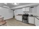 Kitchen featuring stainless steel appliances, white cabinets, and a neutral countertop at 821 Onslow St, Durham, NC 27705