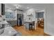 Bright kitchen with stainless steel appliances, island with seating, and view to dining area at 821 Onslow St, Durham, NC 27705