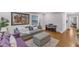 Cozy living room with a gray couch, hardwood floors, piano, and ample natural light at 821 Onslow St, Durham, NC 27705