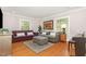 Inviting living room with plush seating, large windows, and hardwood floors at 821 Onslow St, Durham, NC 27705