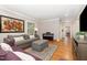 Inviting living room with hardwood floors, a comfortable couch, and an upright piano at 821 Onslow St, Durham, NC 27705
