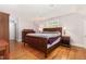 This main bedroom features a wood bed frame, hardwood floors, natural light and tasteful decor at 821 Onslow St, Durham, NC 27705