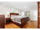 Spacious main bedroom featuring wood floors, a large bed, and bedside tables with lamps at 821 Onslow St, Durham, NC 27705