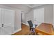 Well-lit home office space with a desk and chair, two doorways, and hardwood floors at 821 Onslow St, Durham, NC 27705