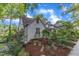 Side view of home featuring lush, established landscaping around the property at 821 Onslow St, Durham, NC 27705