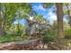 Side view of home showing manicured landscaping and mature trees at 821 Onslow St, Durham, NC 27705