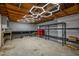 Unfinished basement space with concrete floor and open wooden ceiling with LED lighting at 8620 Glendale Dr, Apex, NC 27539