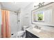 Bright bathroom featuring a shower with glass doors, vanity with sink, mirror and modern fixtures at 8620 Glendale Dr, Apex, NC 27539