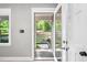 Inviting entryway through glass front door with outdoor views and hardwood floors at 8620 Glendale Dr, Apex, NC 27539