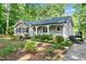 Inviting home with gray siding, black shutters, front garden and an inviting front porch at 8620 Glendale Dr, Apex, NC 27539