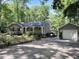 Charming single story home featuring gray siding, white trim, a detached garage and beautiful landscaping at 8620 Glendale Dr, Apex, NC 27539