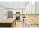 Stylish kitchen featuring granite countertops, stainless appliances, and white cabinets at 8620 Glendale Dr, Apex, NC 27539