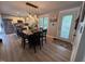Open kitchen and dining area featuring stainless steel appliances and modern lighting fixtures at 8620 Glendale Dr, Apex, NC 27539