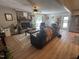 Cozy living room with a brick fireplace, modern furniture, and hardwood floors at 8620 Glendale Dr, Apex, NC 27539