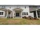 Backyard view of a house with a covered porch and a lawn and an air conditioning unit at 914 Montague Ave, Durham, NC 27703
