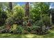 Charming backyard with seating area and decorative features amidst lush greenery at 924 Pebblebrook Dr, Raleigh, NC 27609