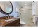 Bright bathroom featuring a vanity, toilet and an enclosed glass shower at 924 Pebblebrook Dr, Raleigh, NC 27609