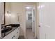 Cozy bathroom with black countertop, stylish vanity, and mirror at 924 Pebblebrook Dr, Raleigh, NC 27609