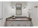 Bathroom featuring granite vanity, and decorative mirror with sconces at 924 Pebblebrook Dr, Raleigh, NC 27609