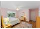 Cozy bedroom featuring wood floors, a ceiling fan, and a bright window at 924 Pebblebrook Dr, Raleigh, NC 27609
