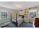 Charming bedroom featuring a poster bed, built-in shelves and natural light at 924 Pebblebrook Dr, Raleigh, NC 27609