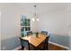 Cozy breakfast nook with a wooden table and large window overlooking the greenery at 924 Pebblebrook Dr, Raleigh, NC 27609