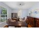 Formal dining room featuring a large table, china cabinet, and natural light at 924 Pebblebrook Dr, Raleigh, NC 27609