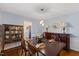 Spacious dining room with a dining table set for four, a china cabinet, and stylish lighting at 924 Pebblebrook Dr, Raleigh, NC 27609