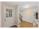Inviting entryway with wood floors, white door, and view of the stairway to the upper level at 924 Pebblebrook Dr, Raleigh, NC 27609