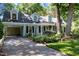 Inviting single-Gathering home features a covered parking area, lush greenery, and traditional dormers for added charm at 924 Pebblebrook Dr, Raleigh, NC 27609