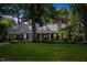 Charming single-Gathering home boasts a lush green lawn and mature trees, complete with a covered porch and traditional dormers at 924 Pebblebrook Dr, Raleigh, NC 27609