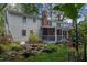 Exterior view of home with screened porch, landscaped garden, and lush greenery at 924 Pebblebrook Dr, Raleigh, NC 27609