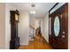 Inviting foyer with gleaming hardwood floors, a grandfather clock, and a stunning front door, creating a warm welcome at 924 Pebblebrook Dr, Raleigh, NC 27609