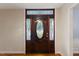 Elegant wooden front door with decorative glass panels, adding a touch of sophistication and classic charm at 924 Pebblebrook Dr, Raleigh, NC 27609