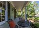 Charming covered porch featuring outdoor seating, classic columns, and views of the beautifully landscaped yard at 924 Pebblebrook Dr, Raleigh, NC 27609